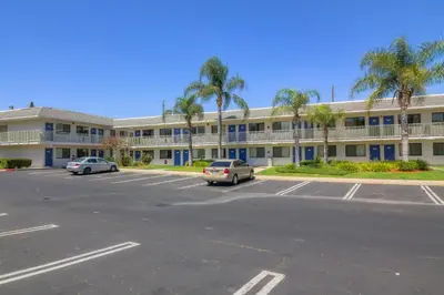 a parking lot in front of a large building at Vagabond Inn Sylmar in Sylmar