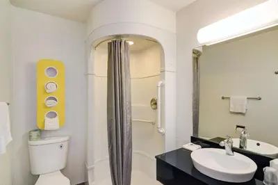 a bathroom with a toilet and a sink and a shower at Vagabond Inn Sylmar in Sylmar