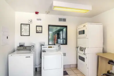 a kitchen with white appliances in a room at Vagabond Inn Sylmar in Sylmar