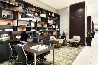 a office with a desk with chairs and a laptop at AC Hotel by Marriott Beverly Hills in Los Angeles