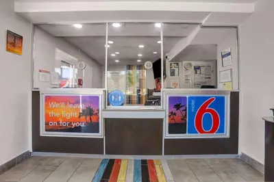 a restaurant with a counter with a sign on it at Motel 6-San Bernardino, CA - North in Serrano Village