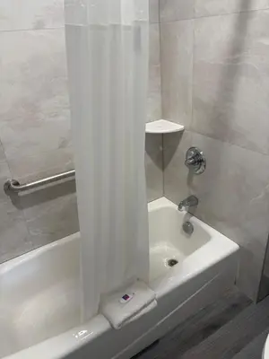 a bathroom with a tub and a shower with a shower curtain at Motel 6-San Bernardino, CA - North in Serrano Village