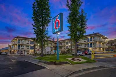 a gas station sign in front of a building at Motel 6-San Bernardino, CA - North in Serrano Village