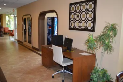 an office with a desk with a computer and a chair at Ontario Airport Inn in Ontario