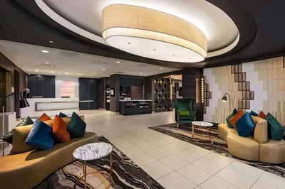 a lobby of a hotel with a couch and chairs at Hilton Garden Inn Los Angeles / Hollywood in Los Angeles