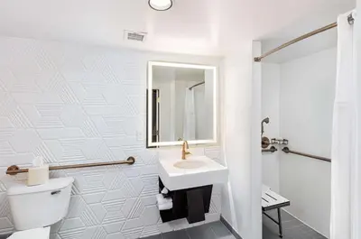 a white bathroom with a sink and a toilet at Hilton Garden Inn Los Angeles / Hollywood in Los Angeles