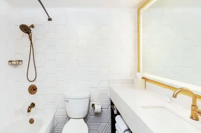a bathroom with a toilet and a sink and a tub at Hilton Garden Inn Los Angeles / Hollywood in Los Angeles