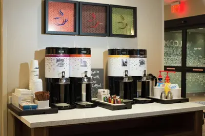 a counter in a store with several coffee machines at Hampton Inn Arvin Tejon Ranch, Ca in Wheeler Ridge