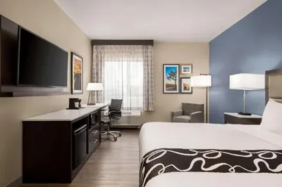 a hotel room with a bed and a flat screen tv at La Quinta Inn & Suites by Wyndham San Bernardino in San Bernardino