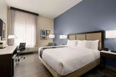 a hotel room with a large bed and a desk at La Quinta Inn & Suites by Wyndham San Bernardino in San Bernardino