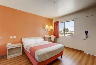 a bedroom with a large bed and a window at Motel 6-Corona, CA in Corona