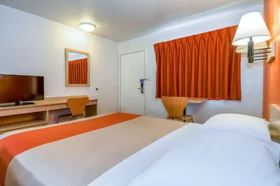 a hotel room with a large bed and a television at Motel 6-Corona, CA in Corona