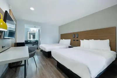 a hotel room with two beds and a desk at Motel 6-Santa Ana, CA in Santa Ana