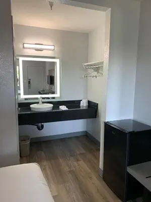 a bathroom with a sink and a mirror at Motel 6-Santa Ana, CA in Santa Ana