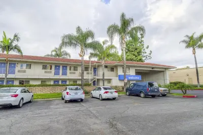 a group of cars parked in front of a building at Motel 6 Chino, CA - Los Angeles Ontario in Chino