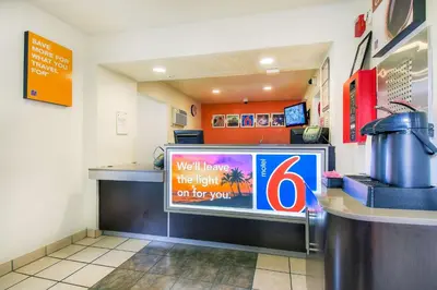 a fast food restaurant with a sign on the counter at Motel 6 Chino, CA - Los Angeles Ontario in Chino