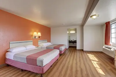 a hotel room with two beds and a bathroom at Motel 6-Bellflower, CA - Los Angeles in Bellflower