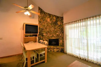 a dining room with a table and a fireplace at Lagonita Lodge in Big Bear Lake