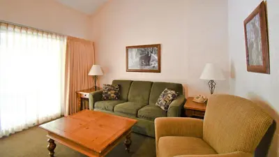 a living room with a couch and a table at Lagonita Lodge in Big Bear Lake