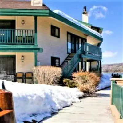 a house with snow in front of it at Lagonita Lodge in Big Bear Lake