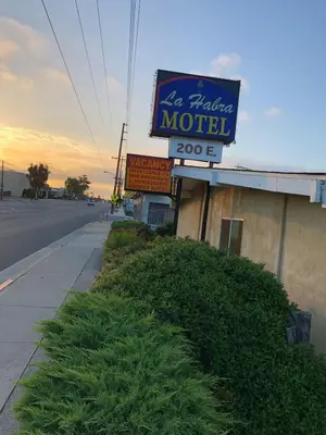 a sign for a motel on the side of a street at La Habra Motel in La Habra