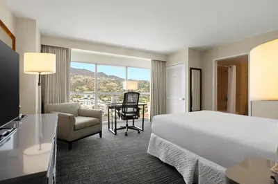 a hotel room with a bed and a desk and chair at Hilton Los Angeles North-Glendale & Executive Meeting Center in Glendale