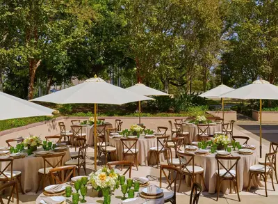 a group of tables and chairs with white umbrellas at Hilton Los Angeles North-Glendale & Executive Meeting Center in Glendale
