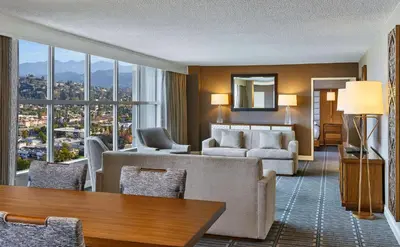a living room with a couch and a table at Hilton Los Angeles North-Glendale & Executive Meeting Center in Glendale