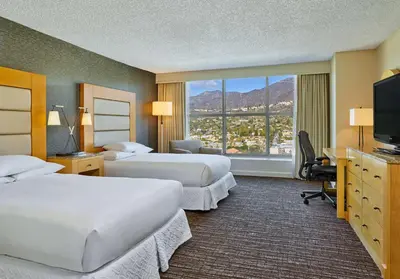 a hotel room with two beds and a large window at Hilton Los Angeles North-Glendale & Executive Meeting Center in Glendale