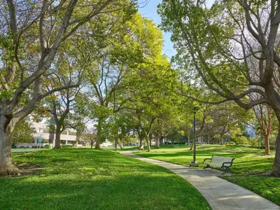 a park with a bench and grass and trees at Hilton Los Angeles North-Glendale & Executive Meeting Center in Glendale