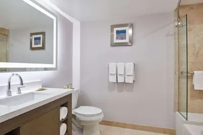 a bathroom with a toilet and a sink and a shower at DoubleTree by Hilton Torrance - South Bay in Torrance