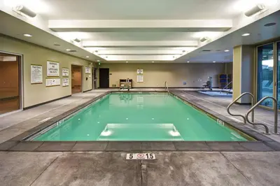 a swimming pool in a building with a sign on it at Home2 Suites by Hilton Los Angeles Montebello in Montebello
