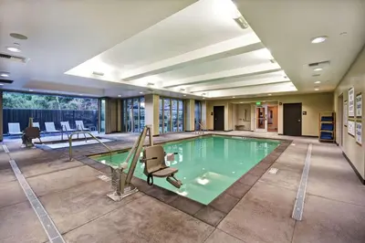 a swimming pool with a slide in a building at Home2 Suites by Hilton Los Angeles Montebello in Montebello