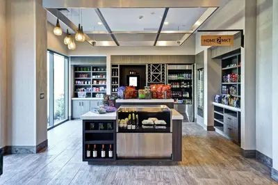 a wine store with a bar in the middle of a room at Home2 Suites by Hilton Los Angeles Montebello in Montebello
