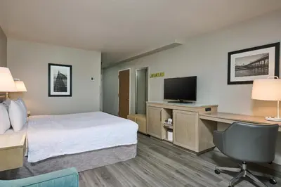 a hotel room with a bed and a desk and a television at Hampton Inn & Suites Hermosa Beach in Hermosa Beach