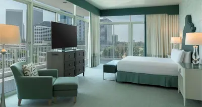 a hotel room with a bed and a television at The Beverly Hilton in Los Angeles