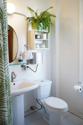 a bathroom with a toilet and a sink and a mirror at The Steady in Los Angeles