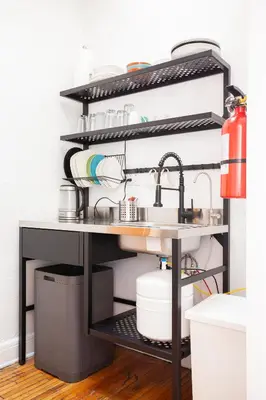 a kitchen shelf with a sink and dishes at The Steady in Los Angeles