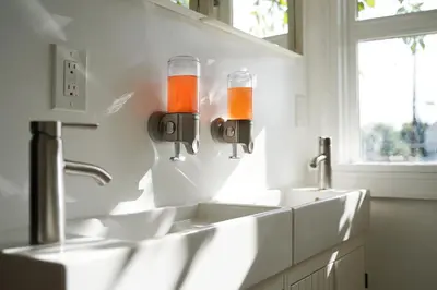 a bathroom with two sinks and two faucets at The Steady in Los Angeles