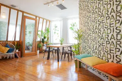 a room with a table and chairs and a wall with words at The Steady in Los Angeles