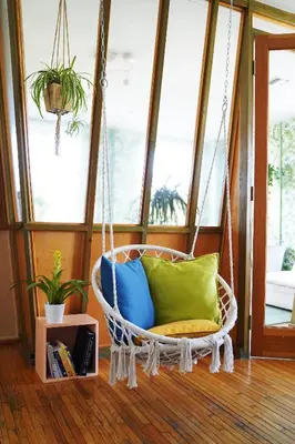 a hanging chair with pillows in a room at The Steady in Los Angeles