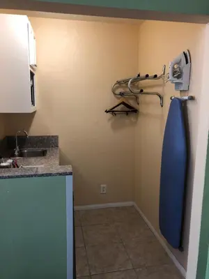 a kitchen with a blue tie hanging on the wall at Encore Motel Near Marina Del Rey, Culver City & Venice in Los Angeles