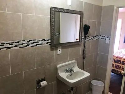 a bathroom with a sink and a mirror at Mount-N-Lake Motel in Wofford Heights
