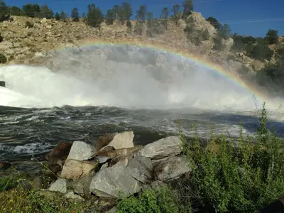 a rainbow over the brink of a waterfall at Mount-N-Lake Motel in Wofford Heights