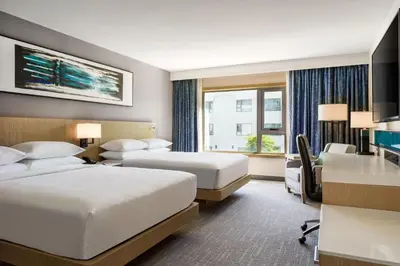 a hotel room with two beds and a desk at Delta Hotels by Marriott Ontario Airport in Ontario