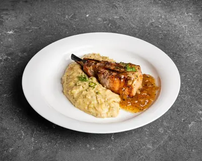a plate of food with meat and mashed potatoes at Delta Hotels by Marriott Ontario Airport in Ontario