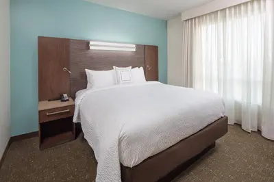 a bedroom with a large bed and a window at Residence Inn by Marriott Ontario Rancho Cucamonga in Rancho Cucamonga