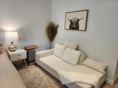 a living room with a couch and a picture of a cow at Heaven's Best Kept Secret 4 Min From The Sea in Pacific Palisades