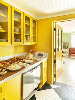 a kitchen with yellow cabinets and food on the counter at Hotel 850 SVB, West Hollywood, a Member of Design Hotels in Los Angeles