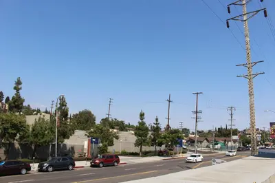 a busy city street with cars parked on the road at ERTH INN by AGA Los Angeles in Los Angeles